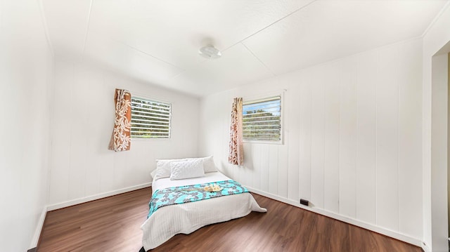 bedroom with wood finished floors and baseboards