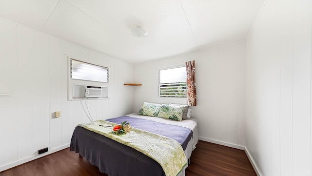 bedroom featuring baseboards, cooling unit, and dark wood-style flooring