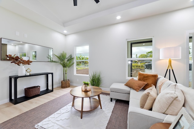 living area with recessed lighting, ceiling fan, light wood-style flooring, and baseboards