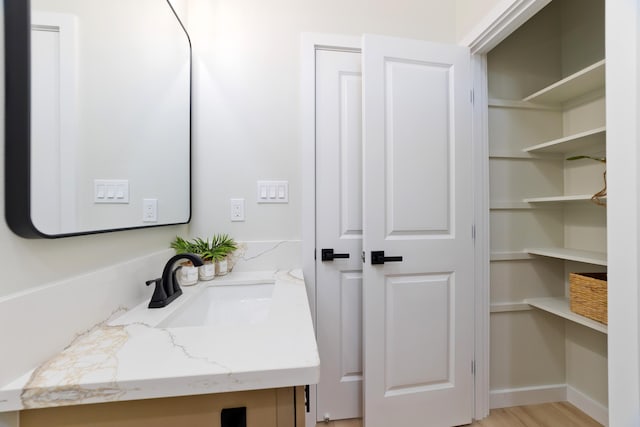 bathroom featuring a closet and vanity