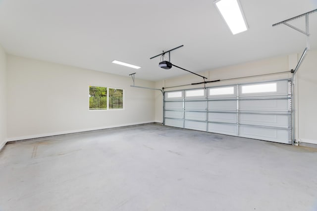 garage with a garage door opener and baseboards