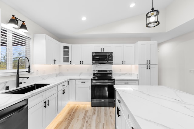 kitchen with black dishwasher, electric stove, stainless steel microwave, glass insert cabinets, and pendant lighting