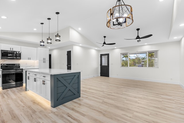 kitchen featuring white cabinetry, stainless steel microwave, pendant lighting, and black electric range oven