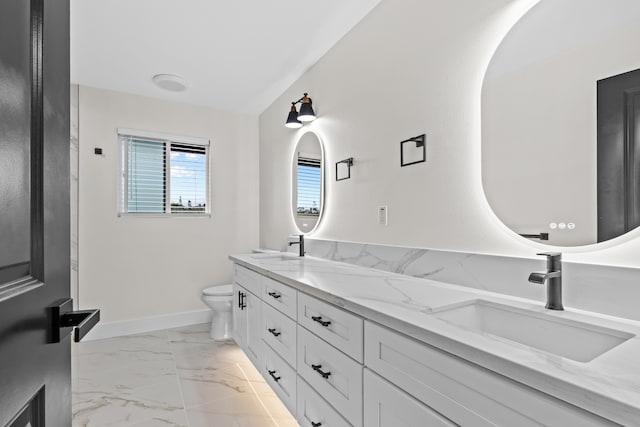 full bath featuring toilet, a sink, baseboards, marble finish floor, and double vanity