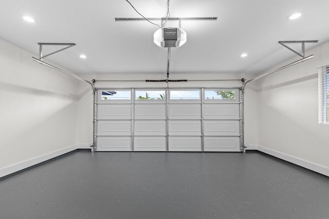 garage with recessed lighting, baseboards, and a garage door opener