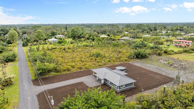 drone / aerial view featuring a view of trees