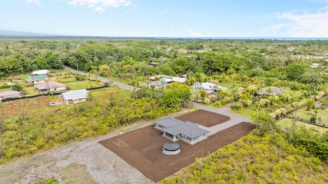 birds eye view of property featuring a wooded view