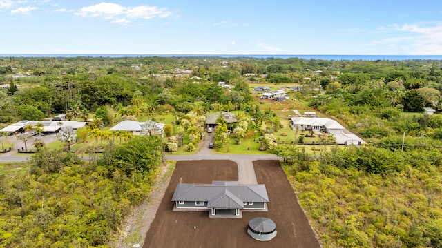 drone / aerial view with a wooded view