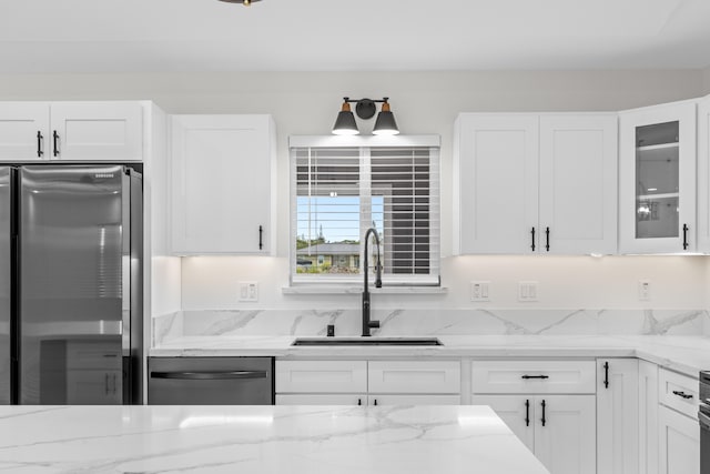 kitchen with white cabinetry, glass insert cabinets, stainless steel appliances, and a sink