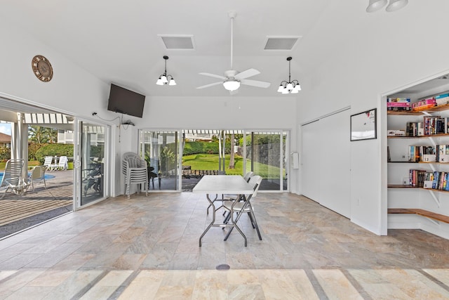 sunroom / solarium featuring vaulted ceiling, visible vents, and ceiling fan