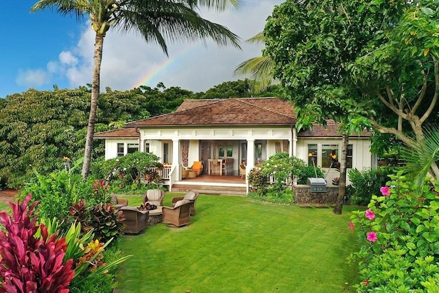 rear view of house with a yard