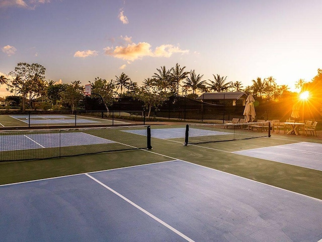 view of tennis court featuring fence