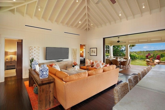 living room with a ceiling fan, high vaulted ceiling, dark wood finished floors, and beam ceiling