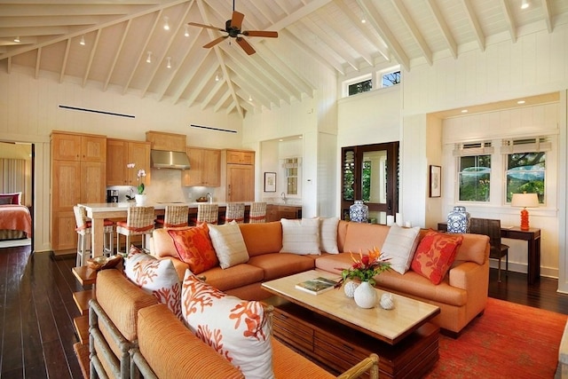 living room with dark wood-style floors, a wealth of natural light, and beamed ceiling