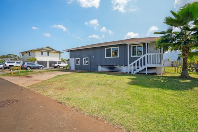 single story home featuring fence, driveway, and a front lawn