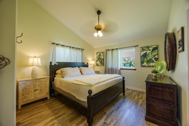 bedroom with lofted ceiling, ceiling fan, baseboards, and wood finished floors