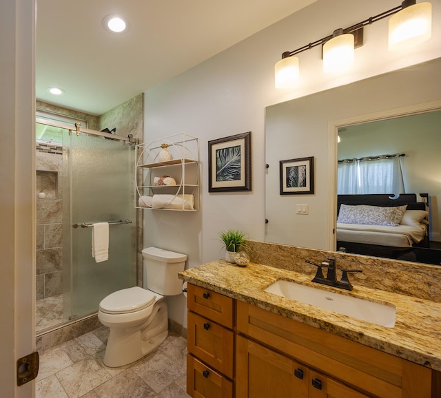 ensuite bathroom featuring connected bathroom, a shower stall, toilet, and vanity