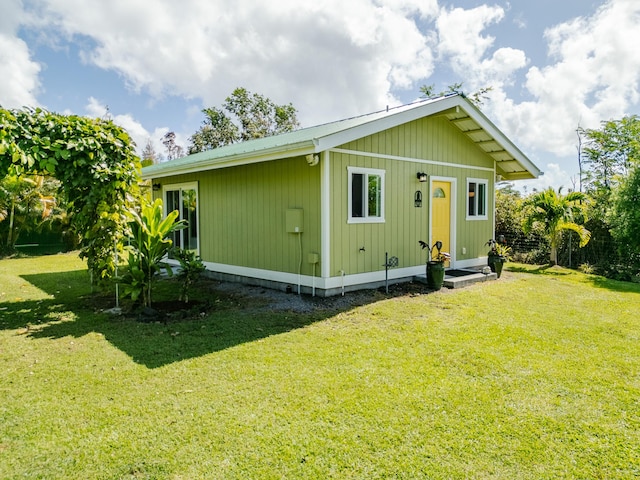 rear view of property with a yard