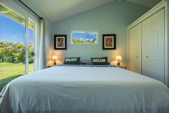 bedroom featuring access to exterior, a closet, and vaulted ceiling