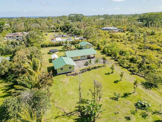 drone / aerial view with a wooded view