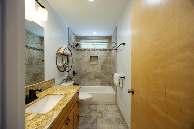 bathroom with shower / bath combination, baseboards, toilet, stone finish flooring, and vanity