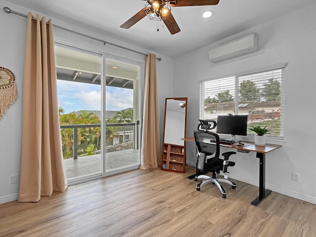 home office with wood finished floors, plenty of natural light, baseboards, and a wall mounted AC