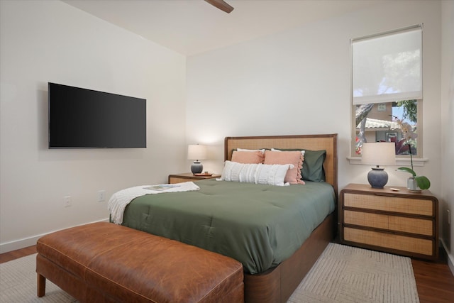 bedroom featuring ceiling fan, wood finished floors, and baseboards