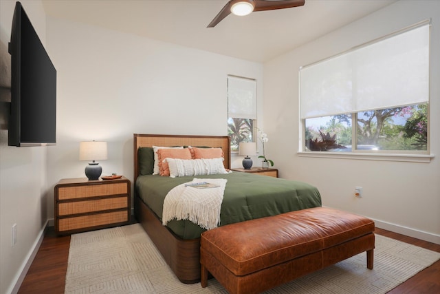 bedroom with a ceiling fan, baseboards, and wood finished floors