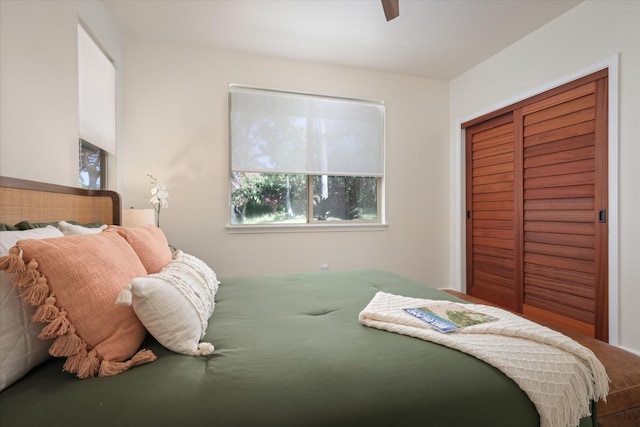 bedroom with ceiling fan and a closet