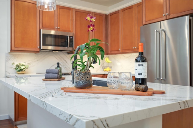 kitchen featuring stainless steel appliances, brown cabinets, and decorative backsplash