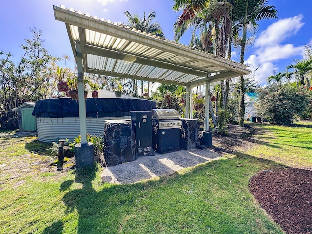 view of vehicle parking featuring a storage shed and a carport