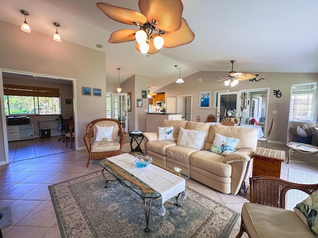 living room with lofted ceiling, a healthy amount of sunlight, and light tile patterned flooring