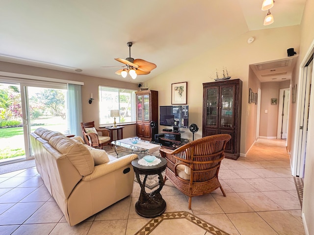 living room with lofted ceiling, light tile patterned floors, ceiling fan, and baseboards