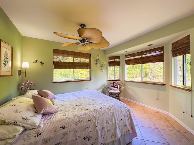 bedroom featuring light tile patterned floors, ceiling fan, and baseboards