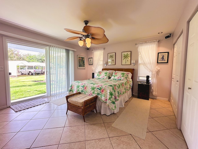 bedroom with access to exterior, light tile patterned floors, baseboards, and a ceiling fan