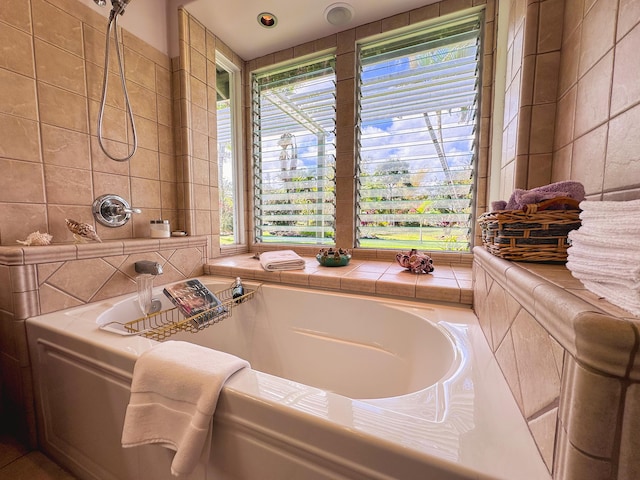 full bathroom featuring a healthy amount of sunlight, a garden tub, and tile walls