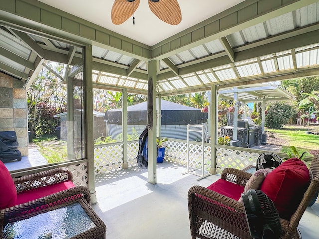 sunroom featuring a ceiling fan