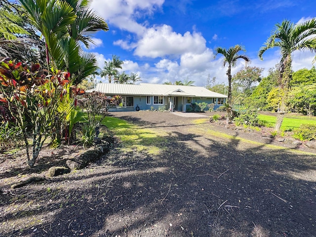 rear view of property featuring metal roof