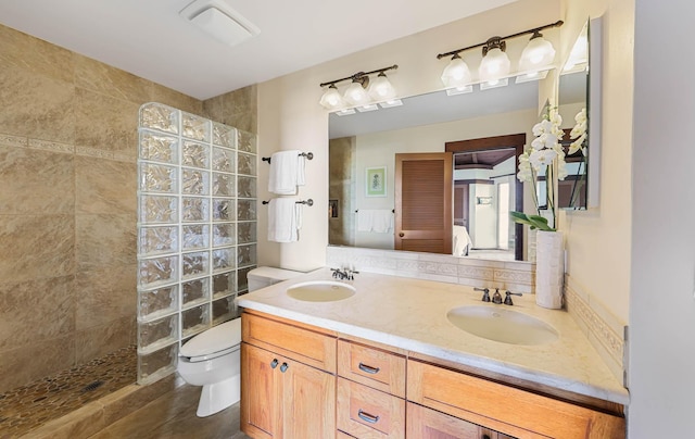 ensuite bathroom featuring double vanity, a sink, ensuite bath, and walk in shower