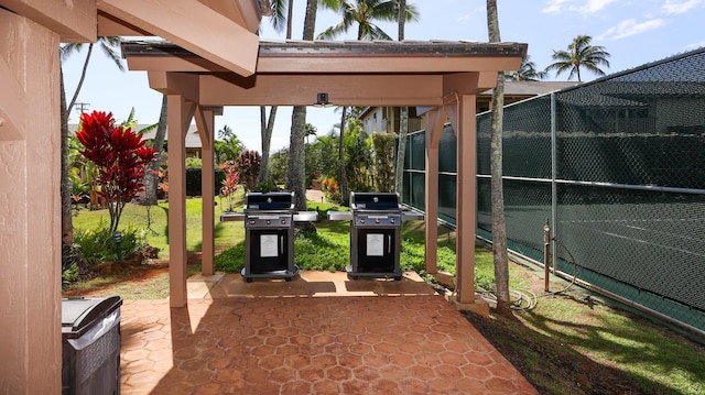 view of patio featuring grilling area and fence