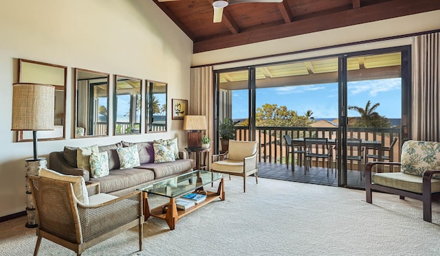 living area featuring carpet floors, beam ceiling, plenty of natural light, and wood ceiling