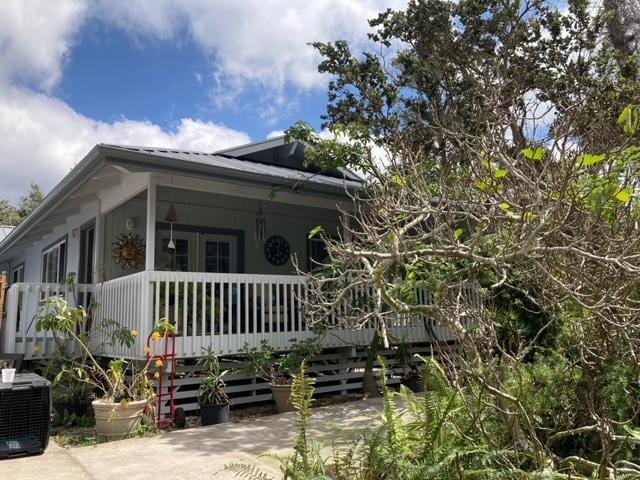 view of home's exterior featuring a porch and central AC