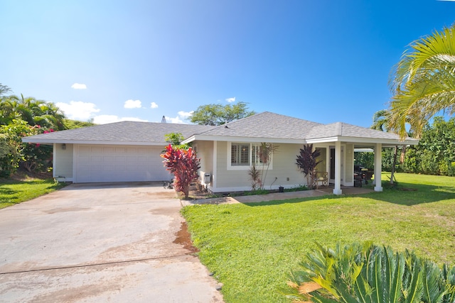 ranch-style home featuring a front lawn, driveway, and an attached garage