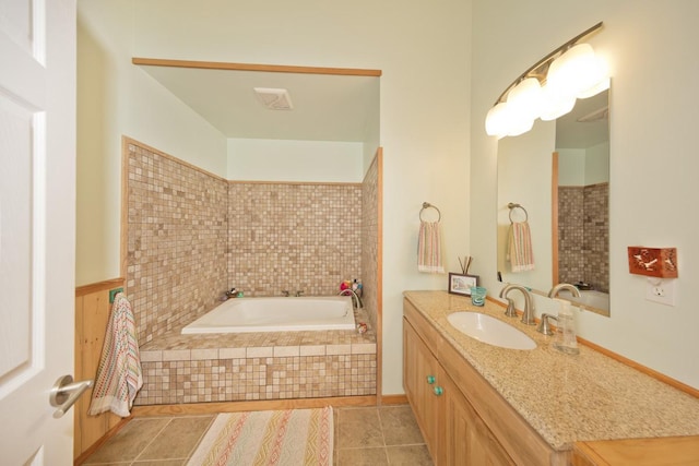 full bathroom with a garden tub, vanity, and tile patterned floors