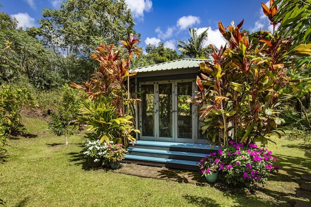 view of outbuilding with entry steps and french doors