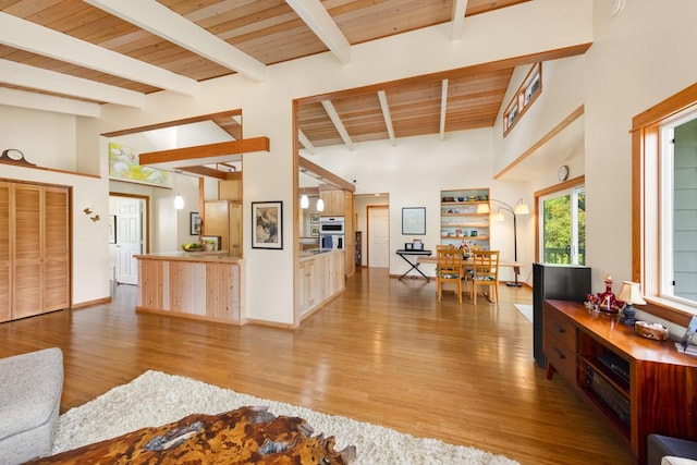 living area featuring high vaulted ceiling, wood ceiling, and wood finished floors