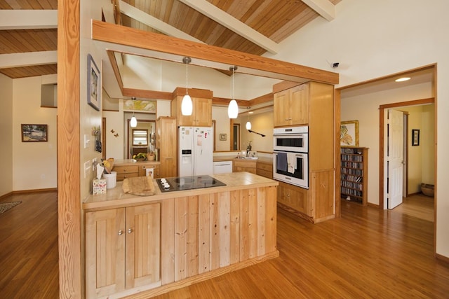 kitchen with white appliances, lofted ceiling with beams, wood finished floors, a peninsula, and a sink