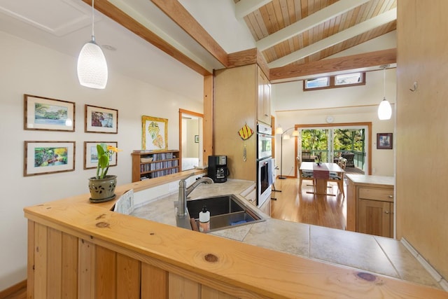 bar with lofted ceiling with beams, double oven, wood finished floors, a sink, and pendant lighting