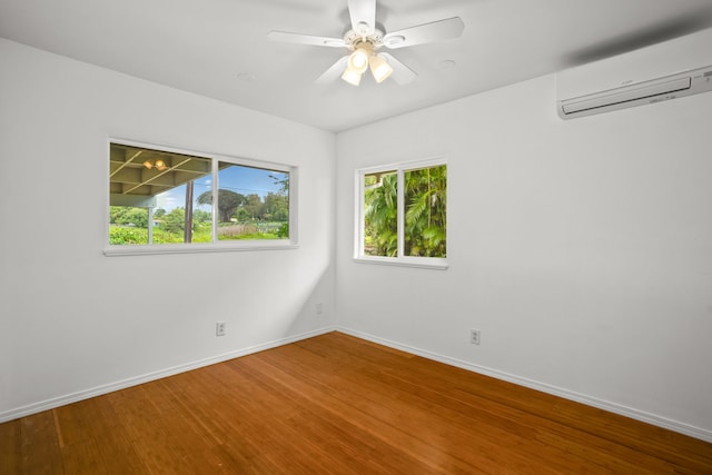 6450 Olohena Rd, Kapaa, HI 96746 - spare room featuring a wall mounted air conditioner, wood finished floors, baseboards, and ceiling fan