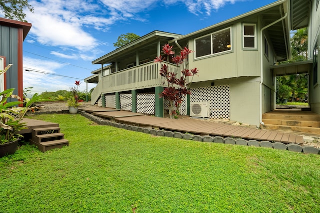 6450 Olohena Rd, Kapaa, HI 96746 - back of house featuring a cooling unit, a yard, a deck, concrete block siding, and stairway